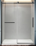 Modern shower enclosure with glass door and black frame in a bathroom setting.