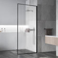 Bathroom with a glass shower door, gray tiles, and a wooden floor.