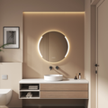 Modern bathroom vanity with round mirror and lighting, featuring a neutral color palette.