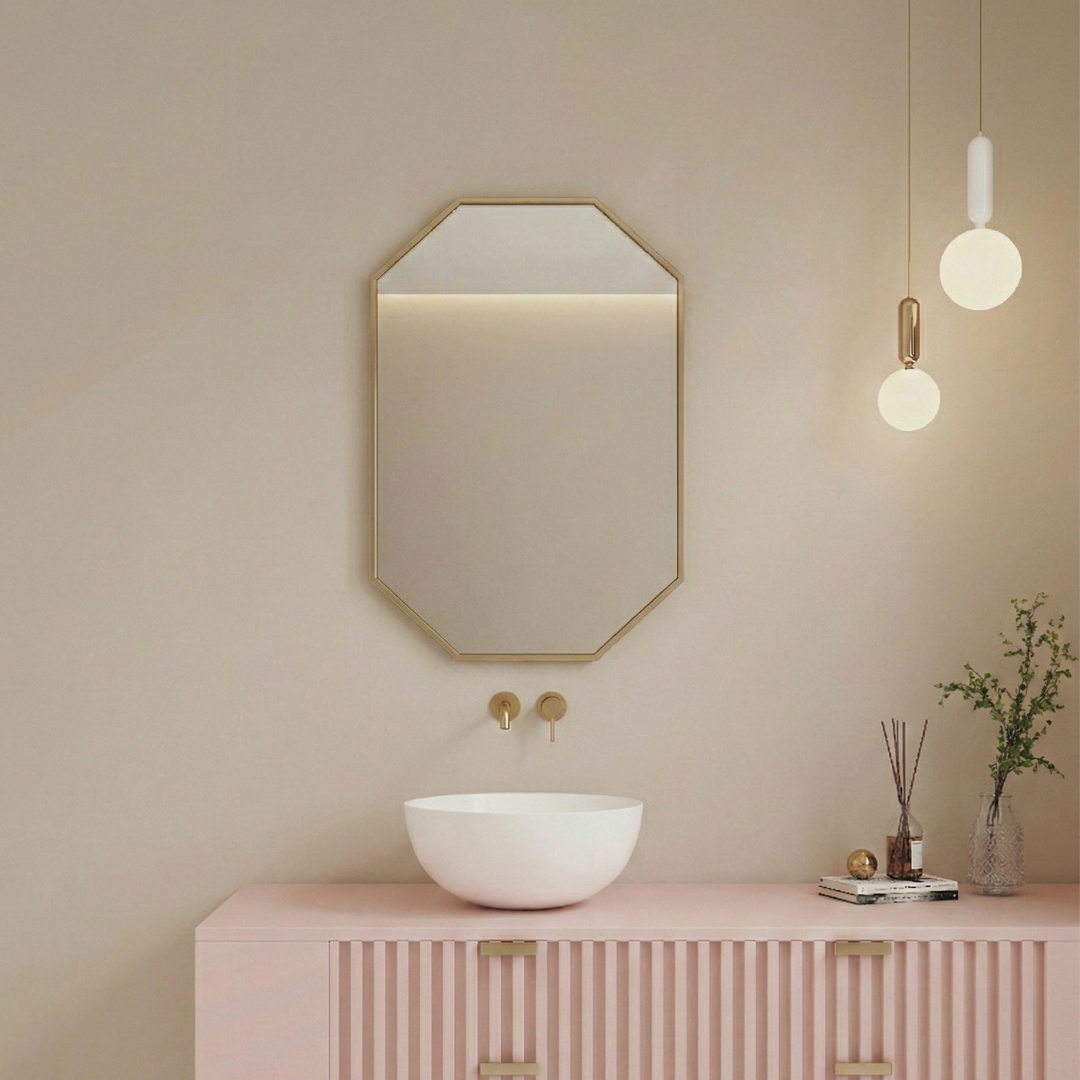 Modern bathroom interior with an octagonal mirror, pink cabinet, and decorative elements.