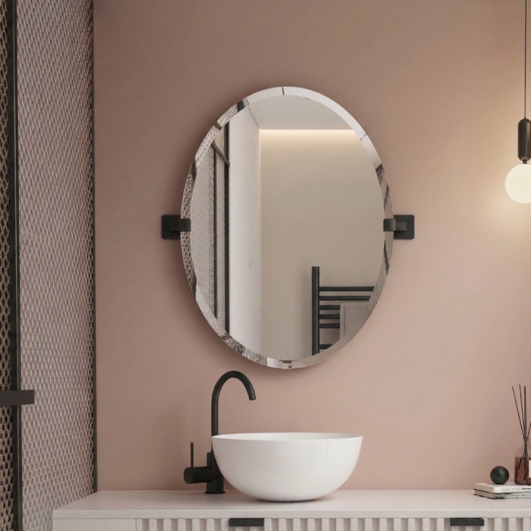Round mirror on a wall above a sink with a black faucet in a bathroom setting.
