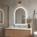 Bathroom with a vanity, sink, and illuminated mirror.