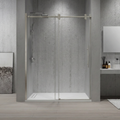 Modern bathroom with a glass shower enclosure and concrete wall.