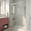 Bathroom with a glass shower enclosure, pink vanity, and white tiles.
