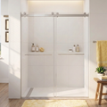 Bathroom with a sliding glass shower door, towels, and a plant.