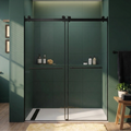 Modern bathroom with a green tiled wall and glass shower enclosure.