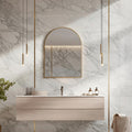 Arched Gold mirror, Modern bathroom with marble walls, a vanity, and decorative elements.
