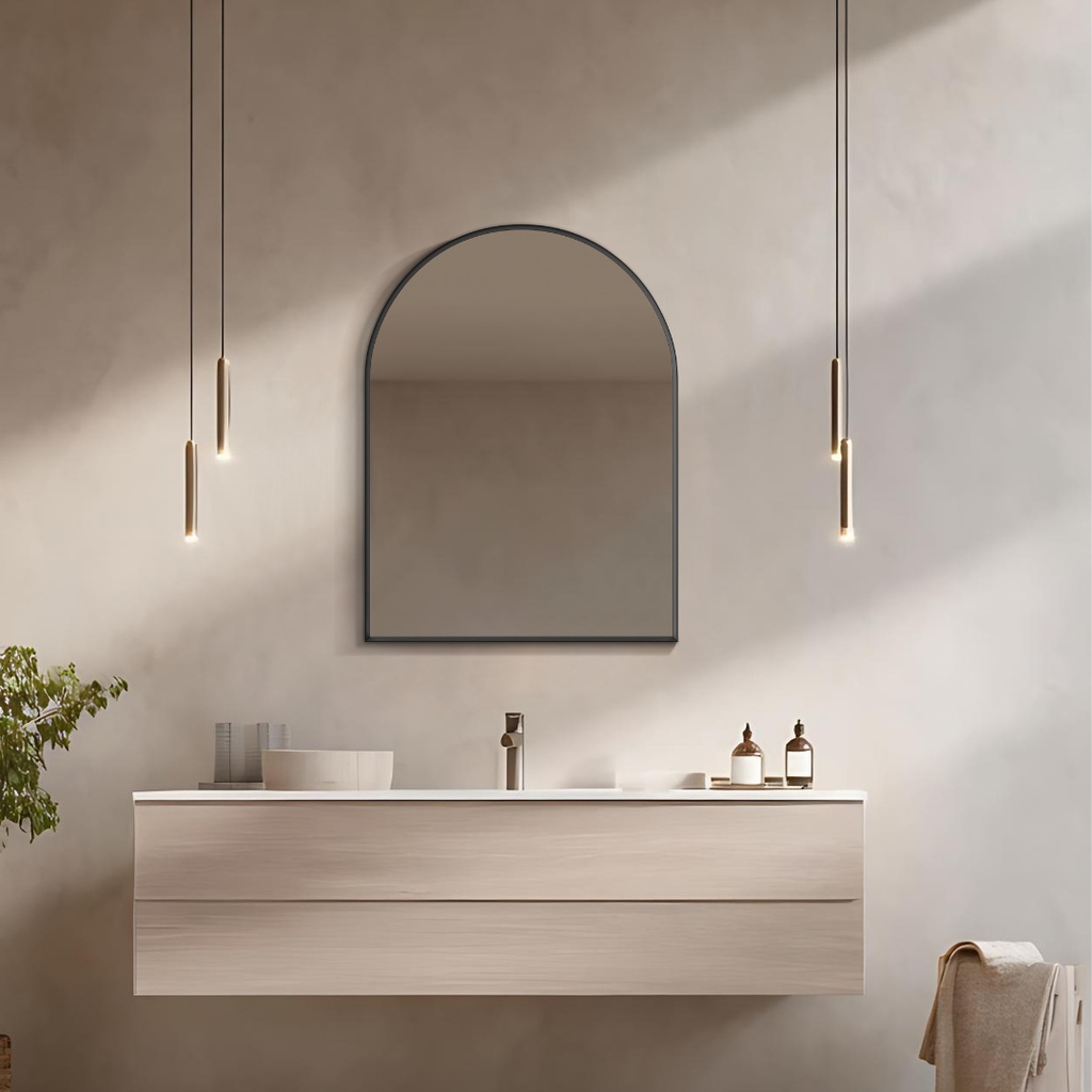 Arched matte black mirror, Modern bathroom with a vanity, mirror, and pendant lights.