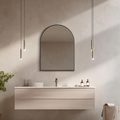 Modern bathroom with a vanity, Arched black mirror, and pendant lights.