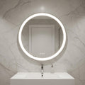 Round illuminated bathroom mirror on a marble wall