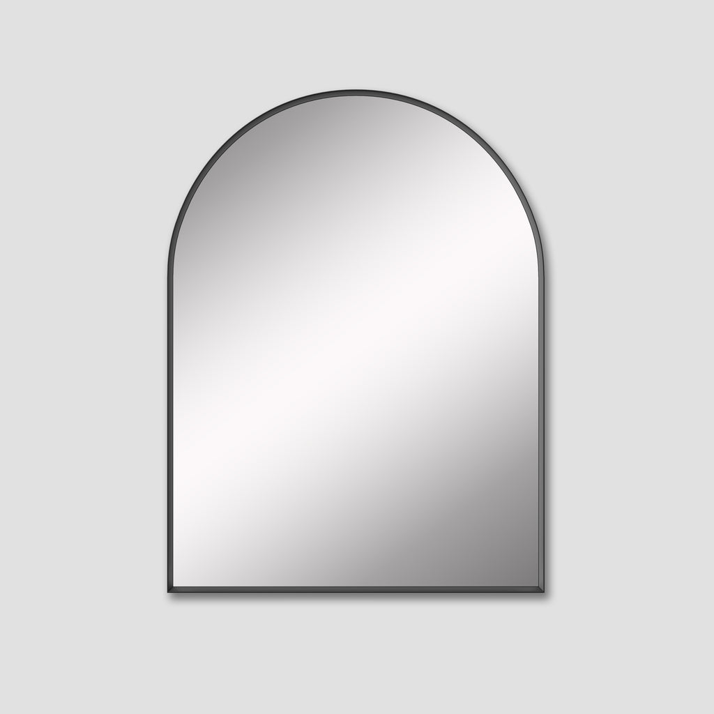 Arched mirror with black frame on a light gray background