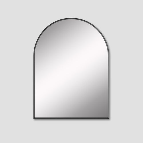 Arched mirror with black frame on a light gray background