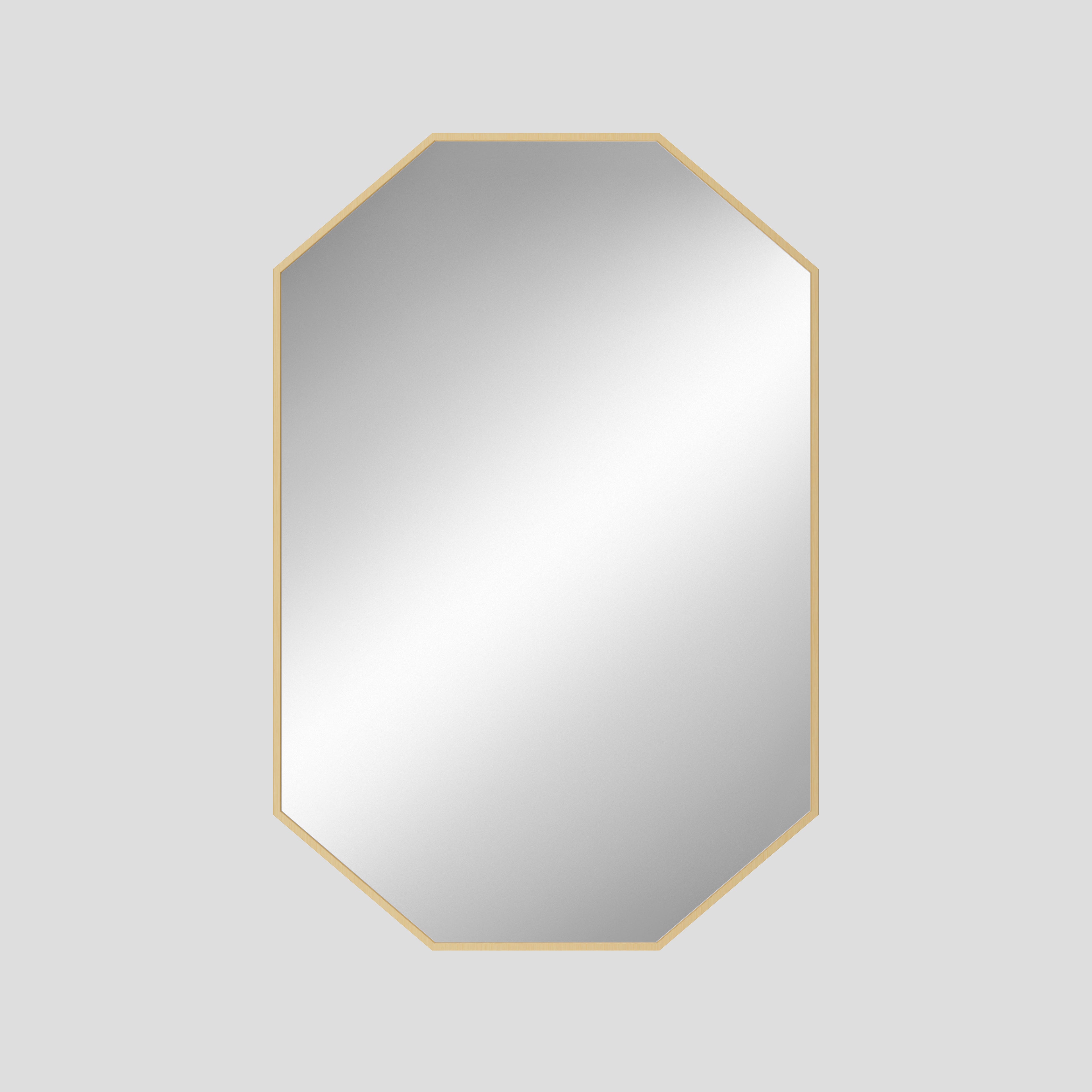 Octagonal mirror with a gold frame on a light gray background