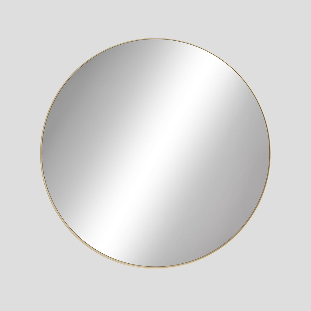 Round mirror with a gold frame on a light gray background