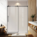 Modern bathroom with a glass shower enclosure, wooden vanity, and marble wall.