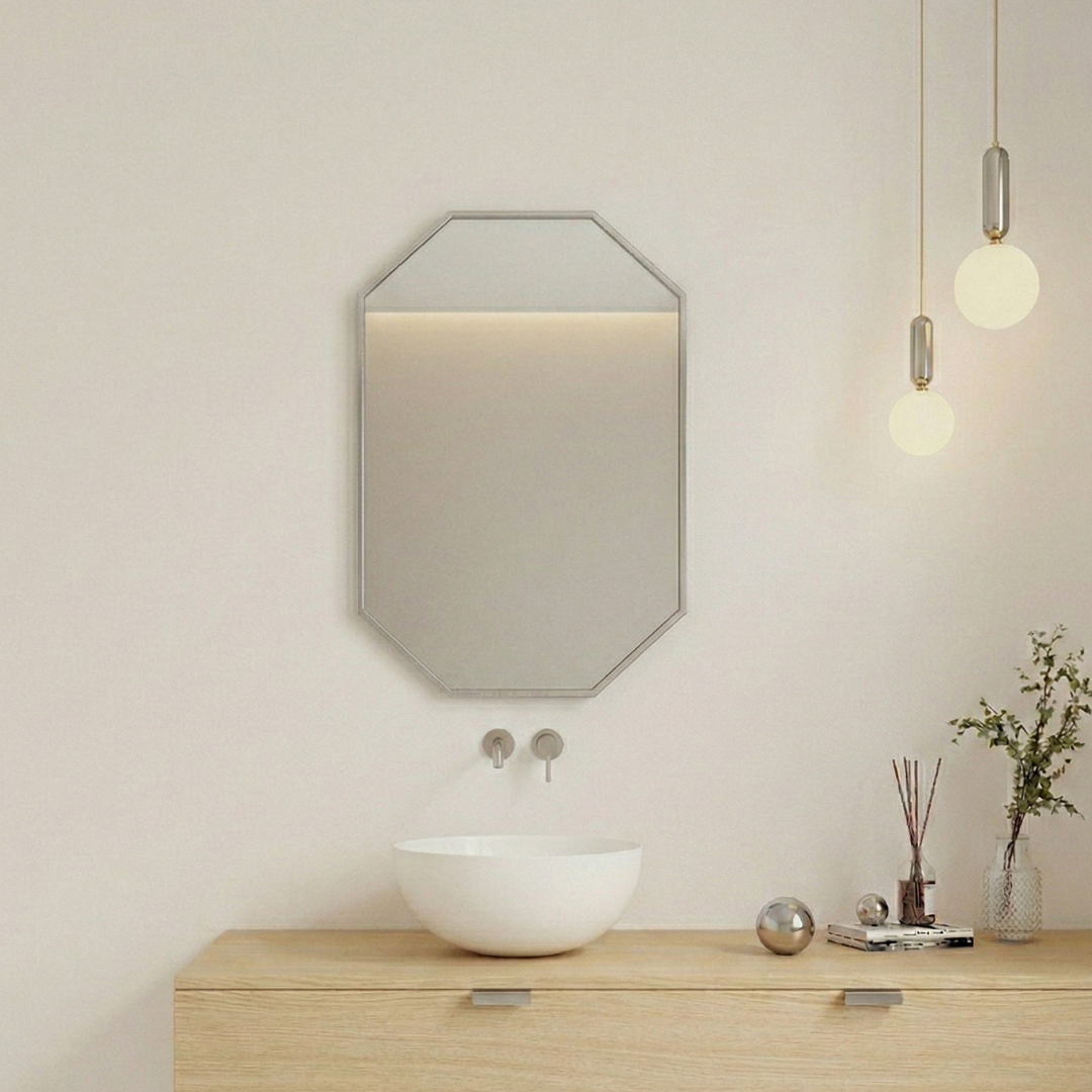 Modern bathroom with octagonal mirror, sink, and decorative elements.