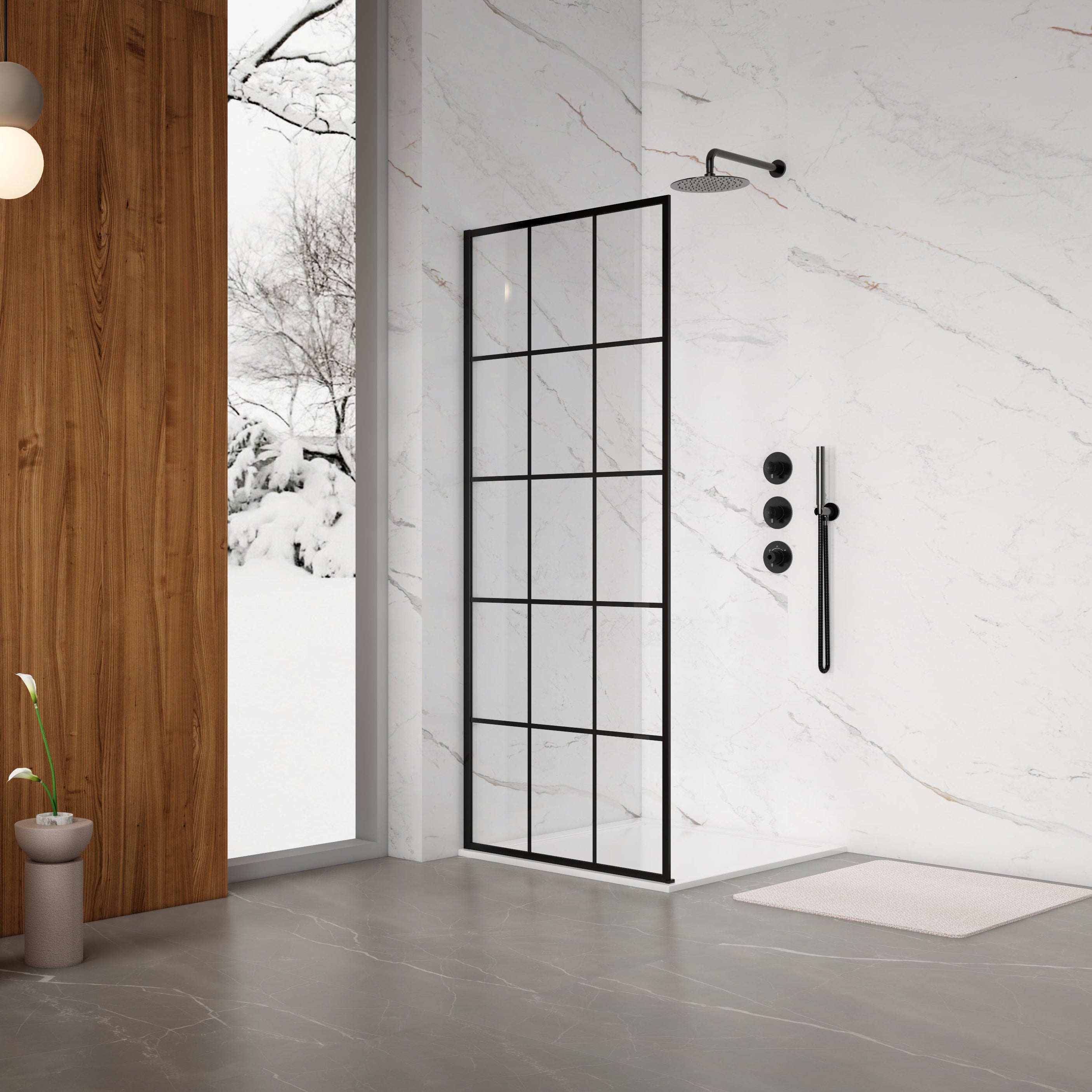 Modern bathroom with a glass shower enclosure, shower head, and control handle.