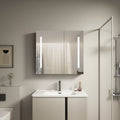 Modern bathroom with a vanity, sink, and illuminated mirror.